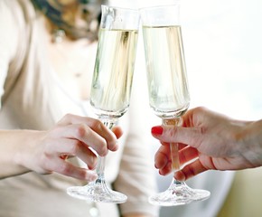 New Year's  glass of sparkling champagne with two women stock photo