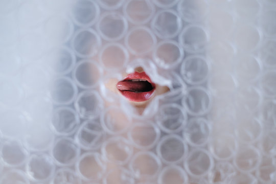 Woman face trough bubble wrap
