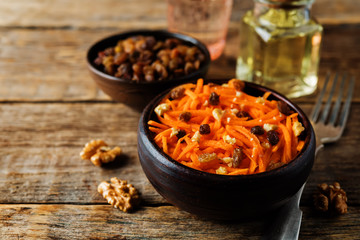 Carrot walnut raisin salad with glass of water