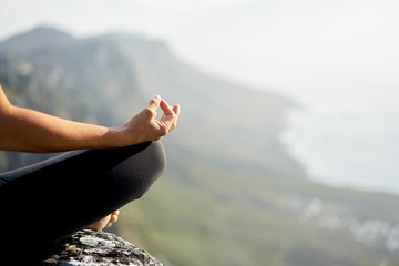 closeup of a female hand in a meditative pose outdoors