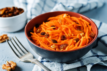 Carrot walnut raisin salad with glass of water