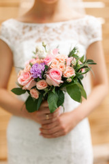 Obraz na płótnie Canvas wedding bouquet in bride's hands