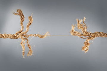Rope near to break on gray background