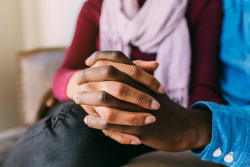 Detail of black couple holding hands
