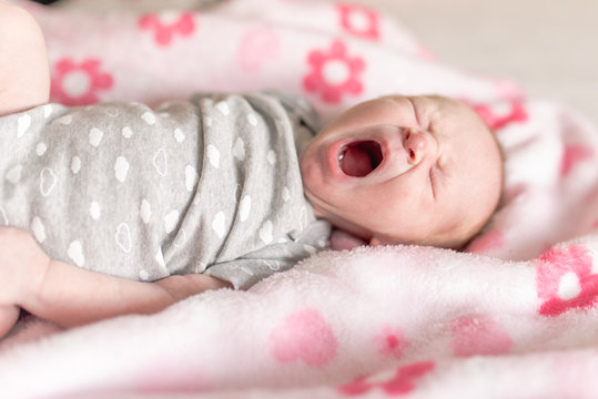 newborn baby girl yawning