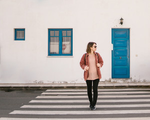 Young casual woman on crosswalk