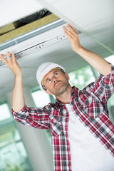 electrician repairing ceiling light