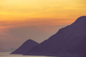 Golden sunset on the sea among the beautiful mountains, the Adriatic Sea. Montenegro.