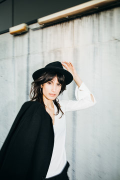 Portrait of young brunette elegant woman walking with blurry