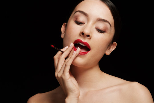 Woman touching up red lips