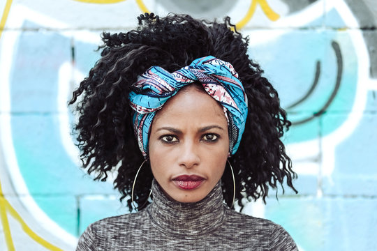 Beautiful Afro Woman in front of a blue wall