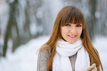 Snowfall in the forest, the girl smiles and poses, a beautiful winter, a great New Year mood