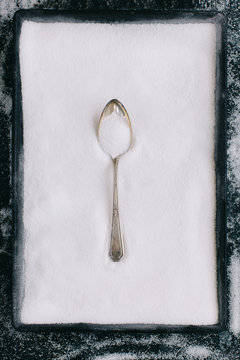 Old fashioned silver spoon on sugar