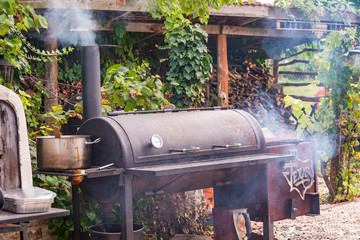 Texas Charcoal offset smoker during backyard cookout