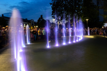 Urban, colored fountains at night.