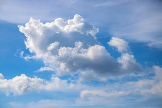 White cloud on blue sky. Sunny cloudscape photo background. Idyllic skyscape with fluffy cloud. Fluffy cloud on sunny sky