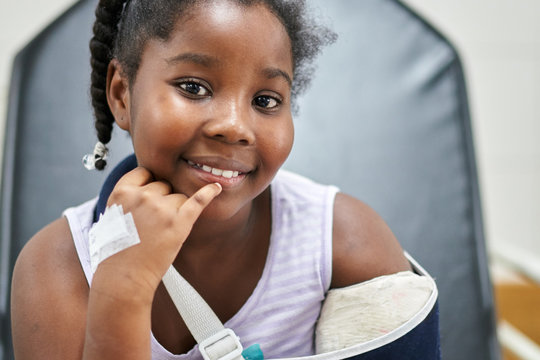 Cute black girl in a hospital with broken arm