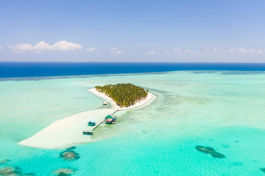 Seascape with a paradise island. Onok Island Balabac, Philippines. A small island with a white sandy beach and bungalows. Philippine Islands.