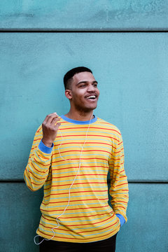 Portrait of a confident young adult listening music