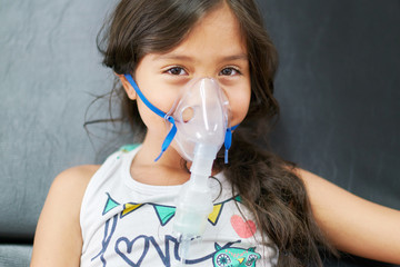 Girl in hospital with respiratory difficulties receiving treatment