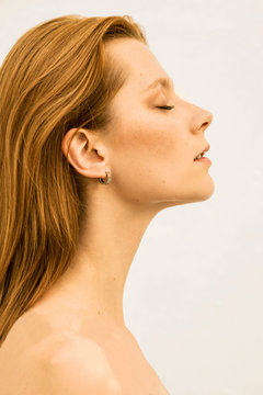 Beautiful red-haired model with closed eyes