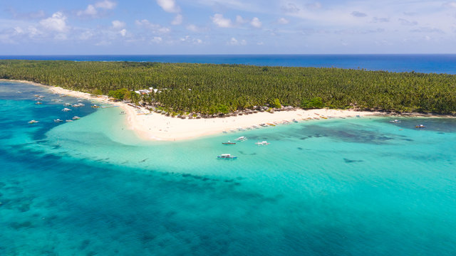 Seascape with a beautiful island. Daco island, Philippines. Tropical island with a white sandy beach for tourists. Island to relax.