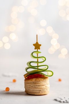 Naklejki Christmas tree canape with cucumber slice, salmon pate and red caviar