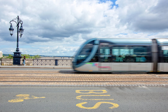 Tramway passing on Pont de Pierre, or the stone bridge in Bordeaux, France