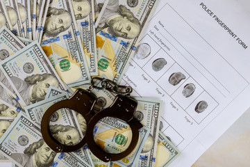 Judge in handcuffs, fingerprint US dollars on a arrest, crime US hundred dollar bills