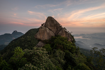 Landscape of rocky mountain peak on rainforest sunset