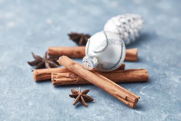 Christmas ball, star anise and cinnamon on bright wooden background. Close up. 