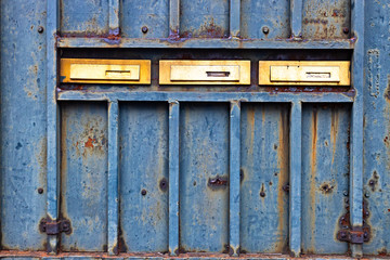 Mail boxes on rusty door