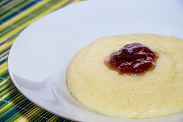 Semolina with jam on a green bamboo background