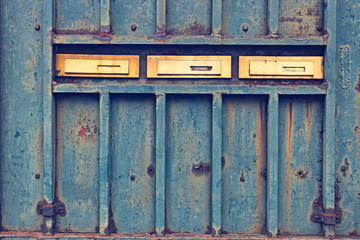 Mail boxes on rusty door