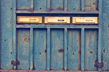 Mail boxes on rusty door