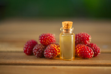 Essence of Wild raspberries  on table in beautiful glass Bottle