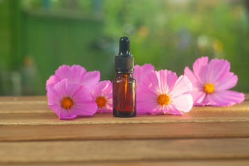 Essence of  flowers on table in beautiful glass Bottle