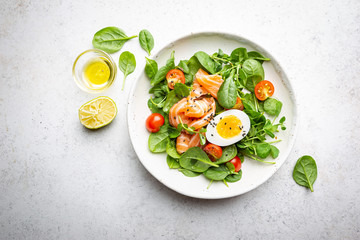 Salad with spinach, Salmon and eggs. Healthy home made food. Concept for a tasty and healthy meal. Top view. Copy space.