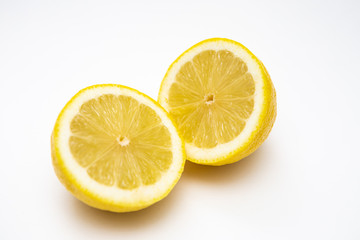 Fototapeta na wymiar Freshly cut lemon. Sliced ​​lemon on white background.