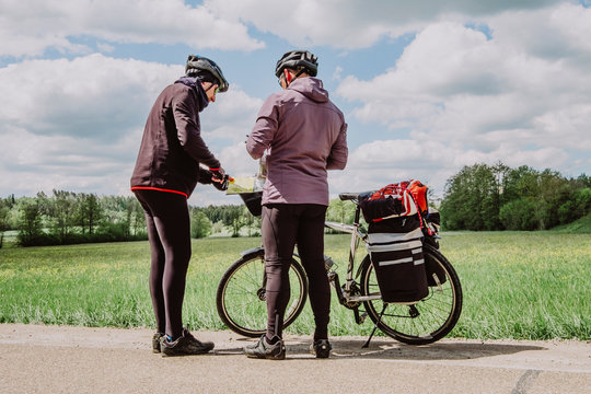 Two cyclists consult the map in the romantische Strasse route, Germany