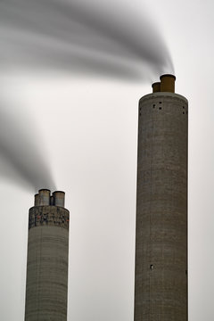 Long exposure of smoke coming out of a factory chimney