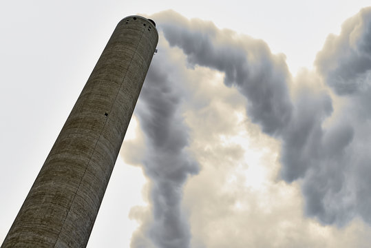 Long exposure of smoke coming out of a factory chimney