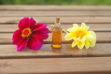 Fototapeta na wymiar dahlia essential oil in beautiful bottle on table