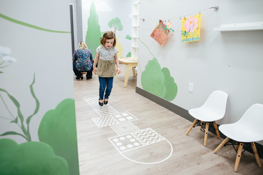 Little Girl Plays Hopscotch At School