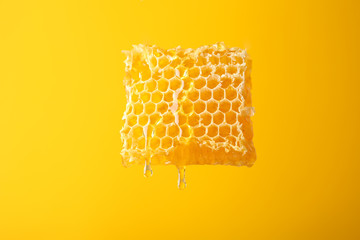 Honeycomb against yellow background, copy space