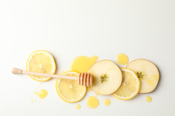 Dipper, honey, apple and lemon slices on white background, top view