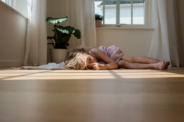 Portrait of a girl looking tired and sleepy sucking her thumb