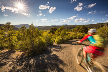 Mountain biker with motion blur riding on a trail in the mountains