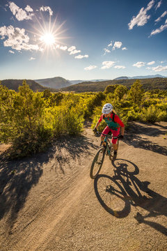 Woman riding a mountain bike outdoors on a sunny day