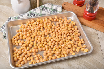 Uncooked garbanzo beans in a baking pan